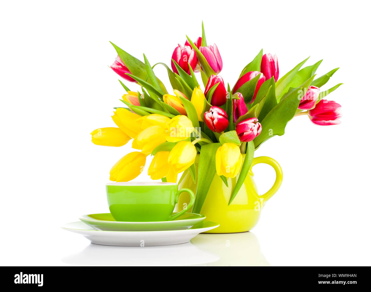 yellow tulips flowers with cup tea, on a white background. breakfast ...
