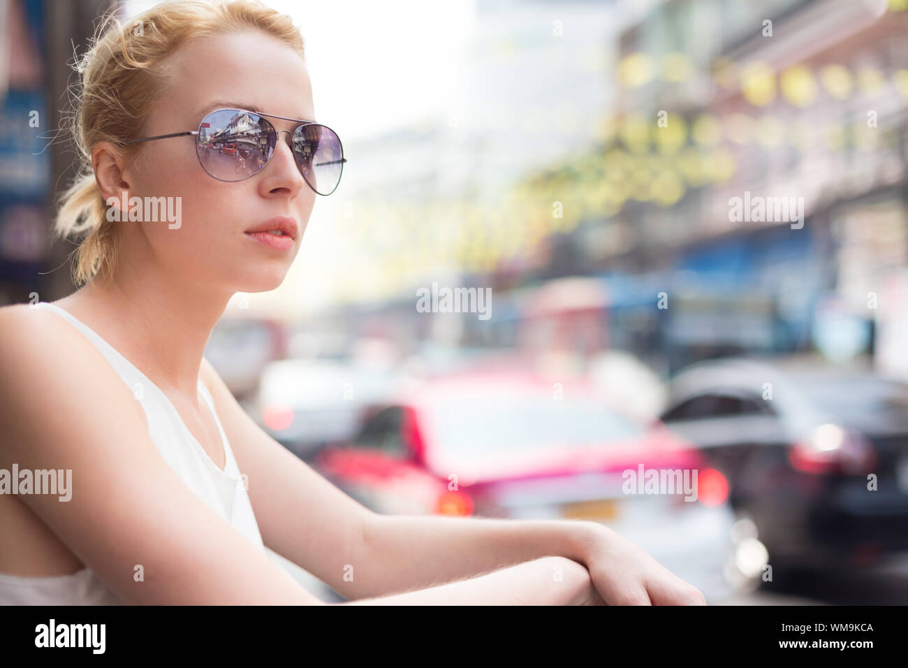 Portrait of Caucasian, Blonde, Female Traveler on the street of Bangkok, Thailand. Street shot. Stock Photo