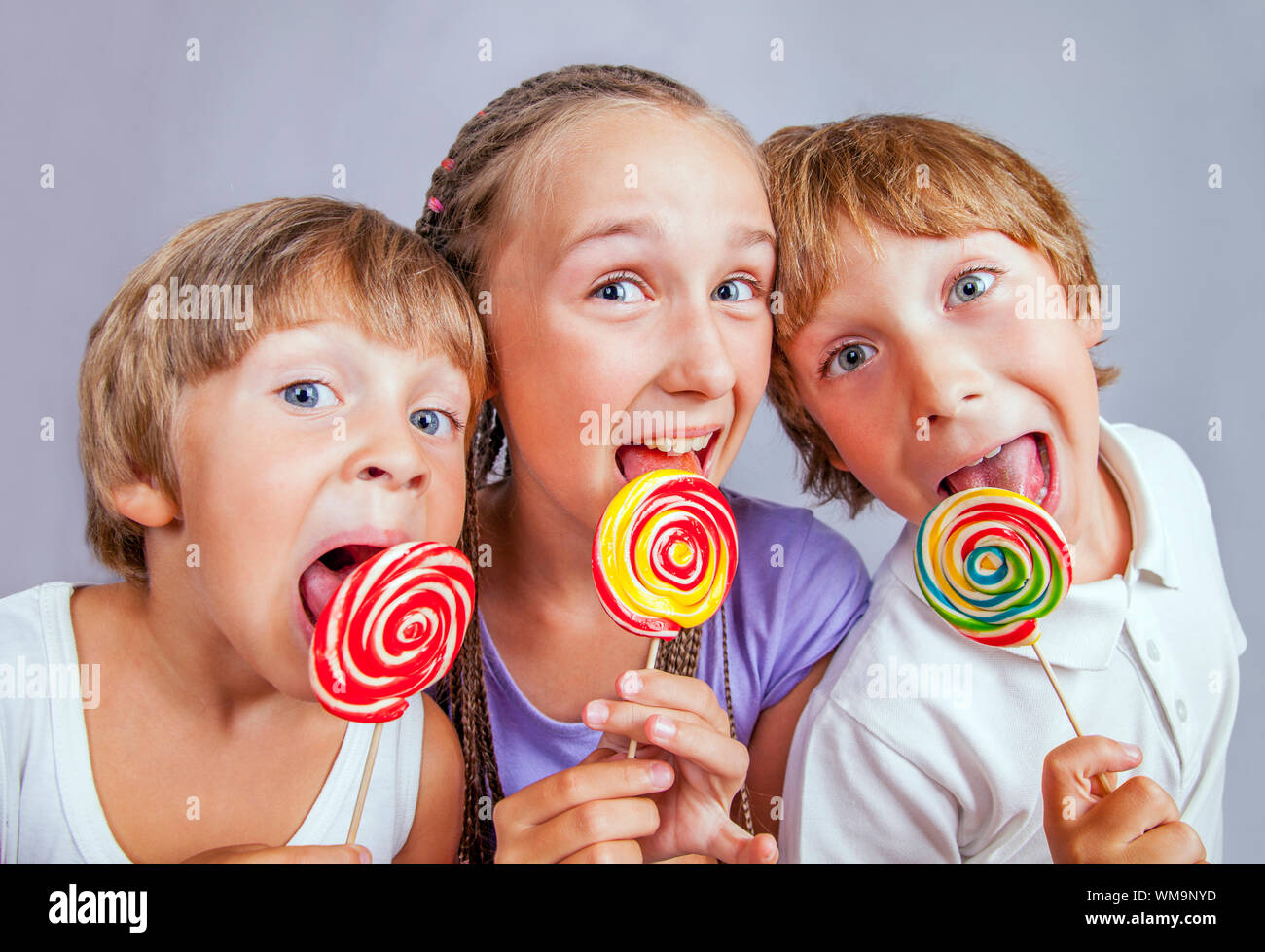 Group of happy children eating candy Stock Photo Alamy