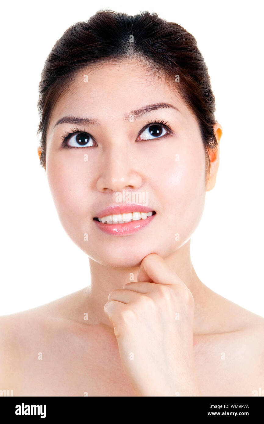 Young Asian girl having a thought with hand on chin Stock Photo - Alamy