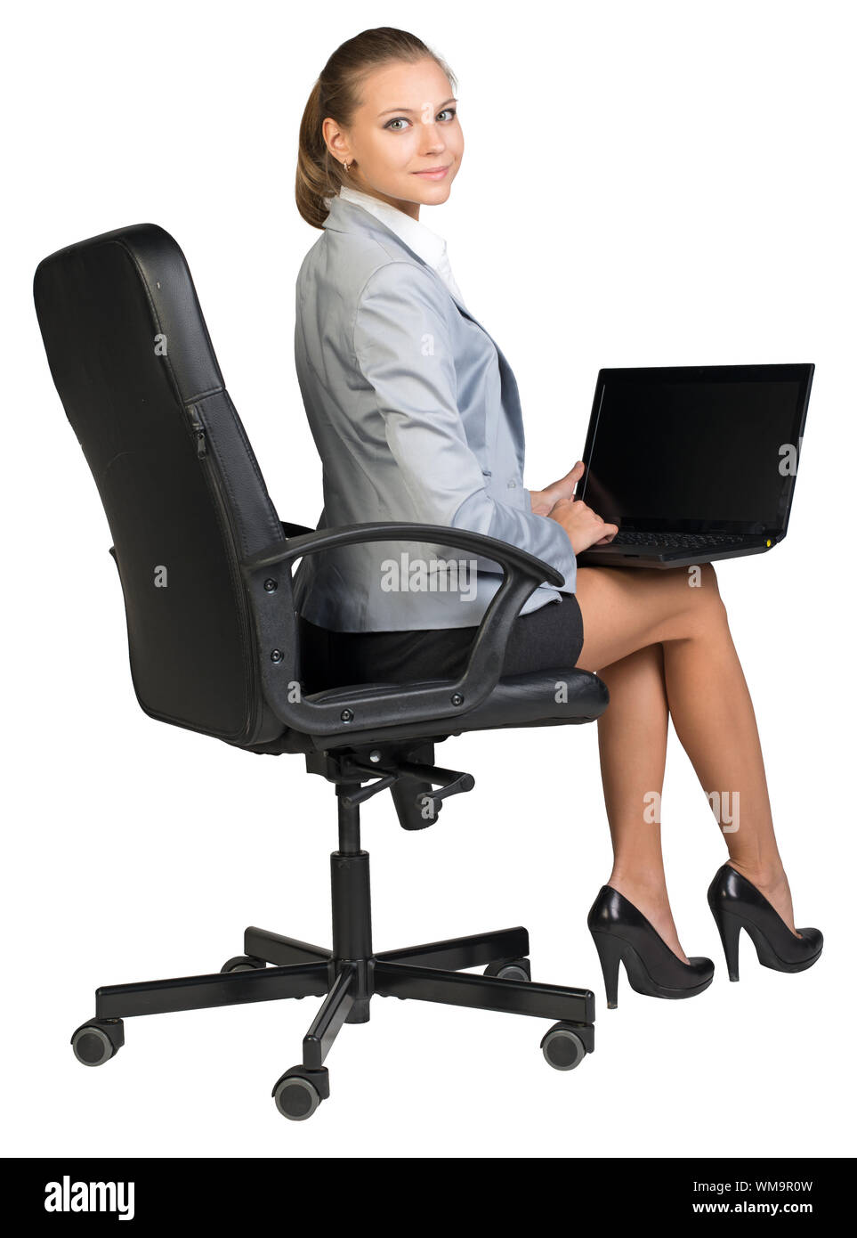 Businesswoman On Office Chair With Laptop On Her Knees Looking