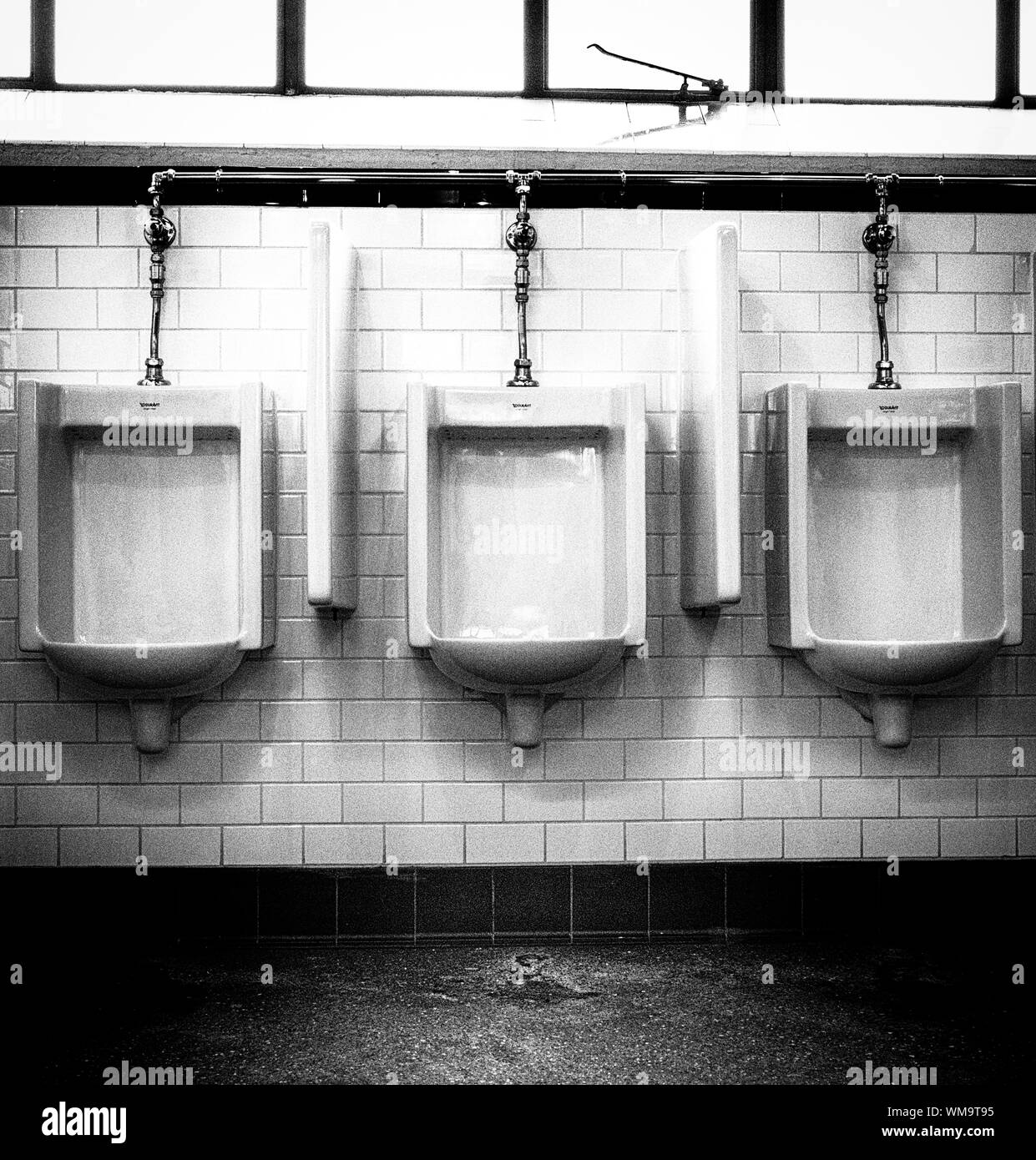 Urinals in public toilet restroom Black and White Stock Photos & Images