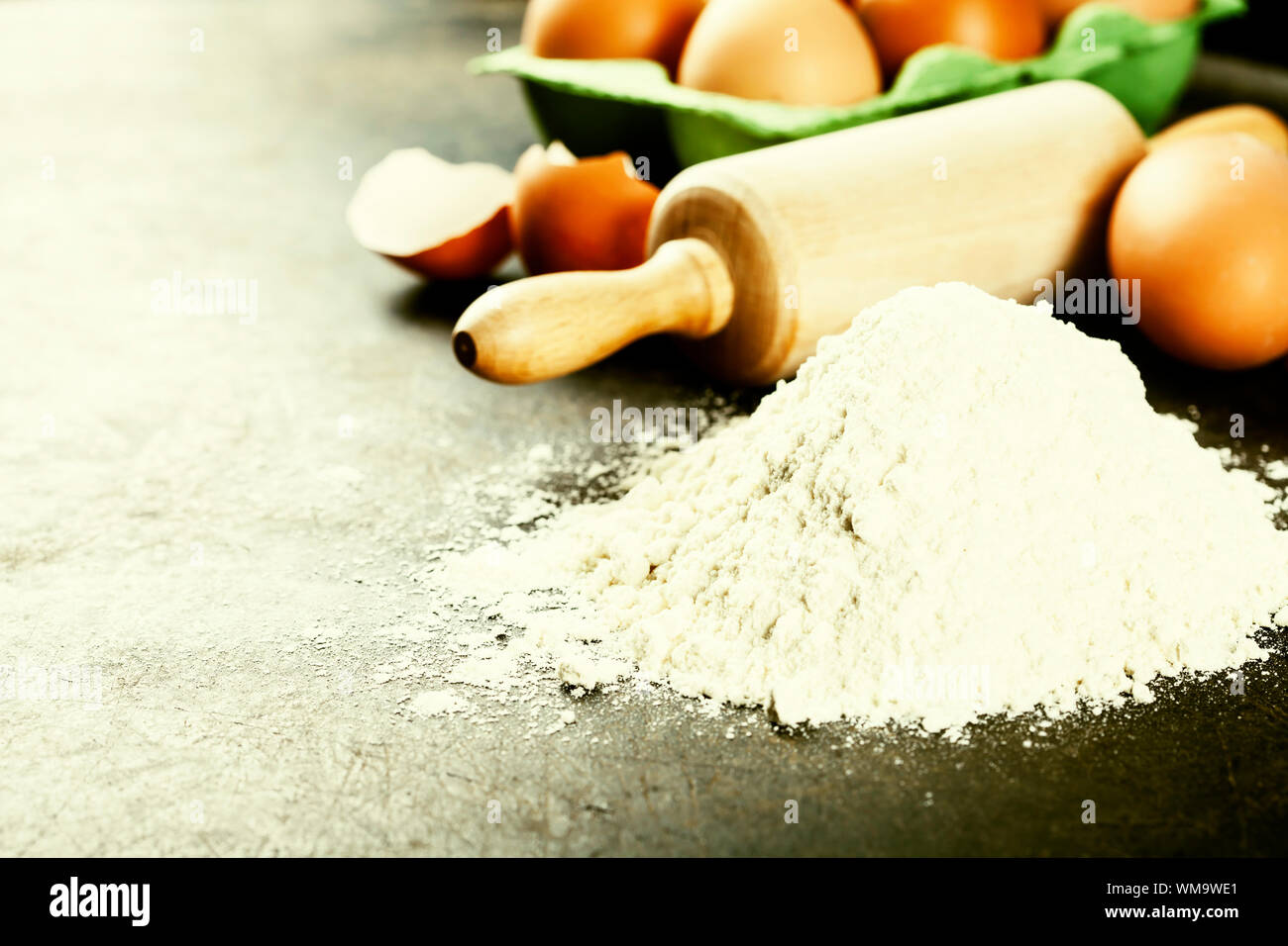baking background with raw eggs, rolling pin and flour Stock Photo - Alamy