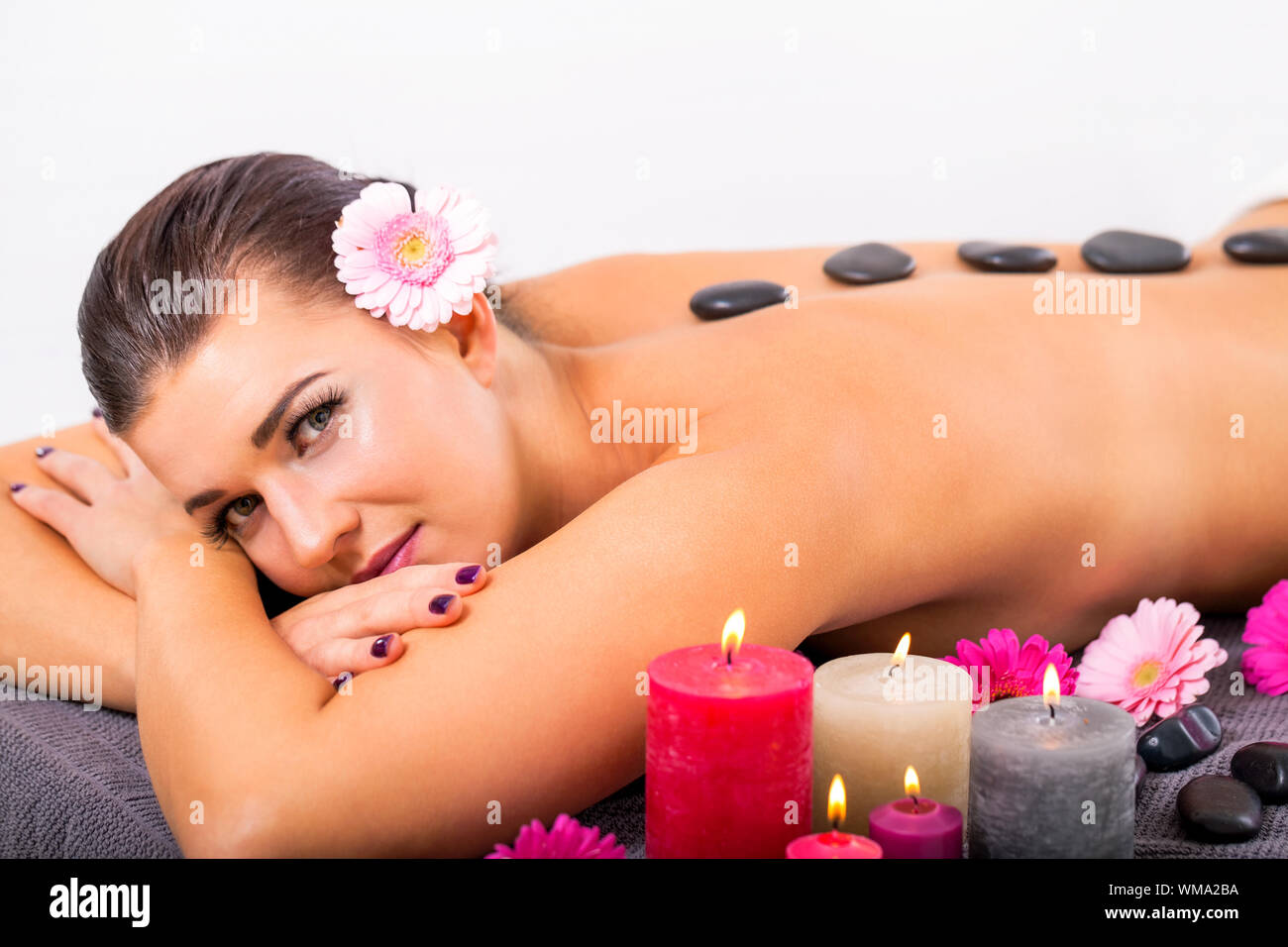 young attractive woman hot stone massage wellness Stock Photo