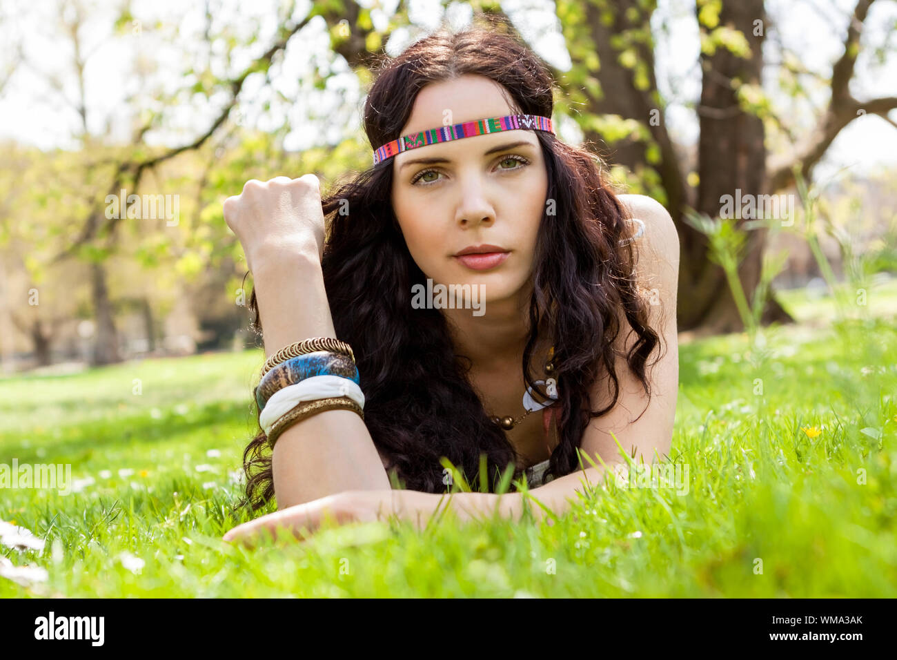 Pretty young woman in a headband daydreaming Stock Photo