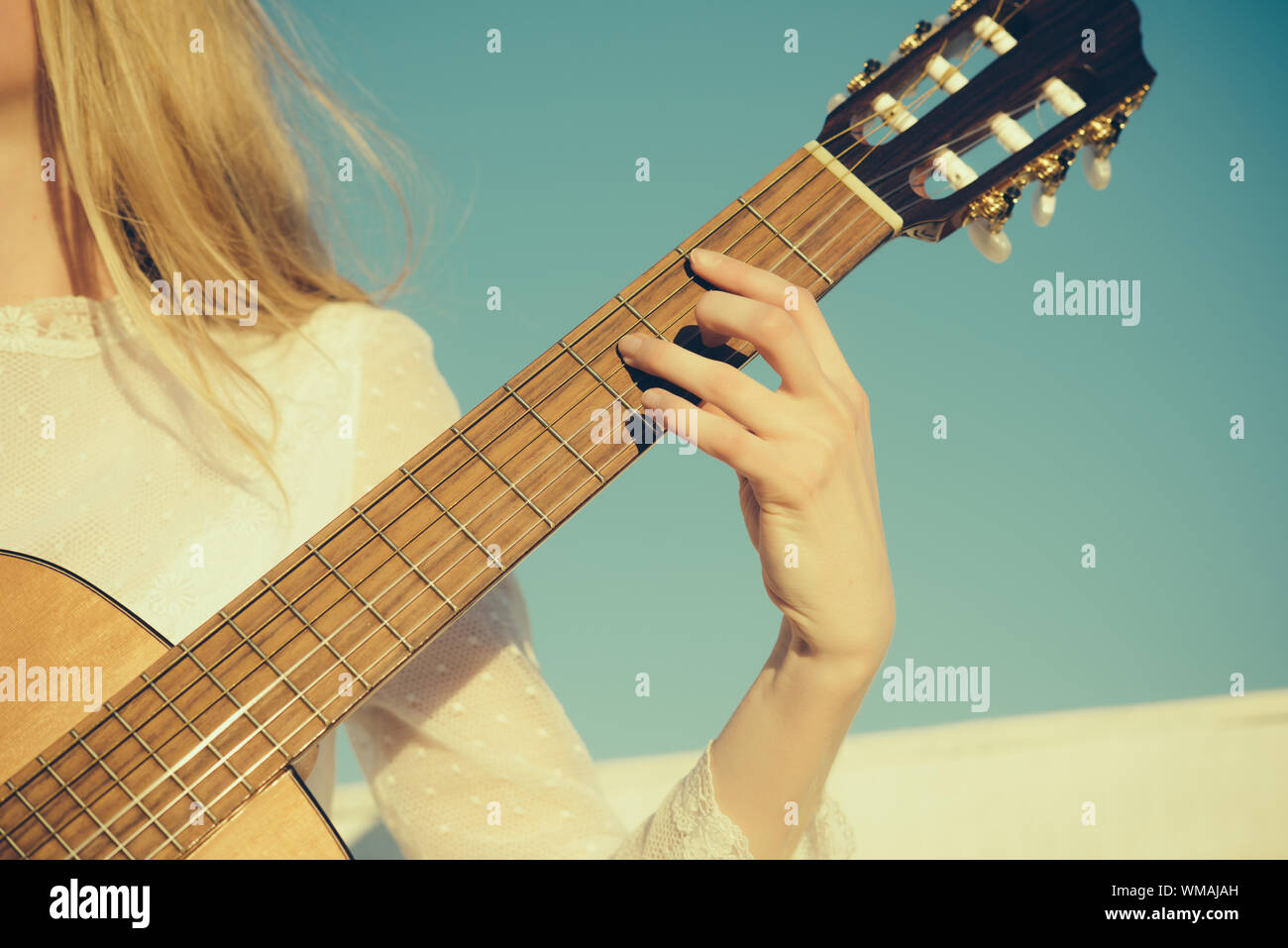 Music and entertainment concept. Guitar with fingers strumming strings