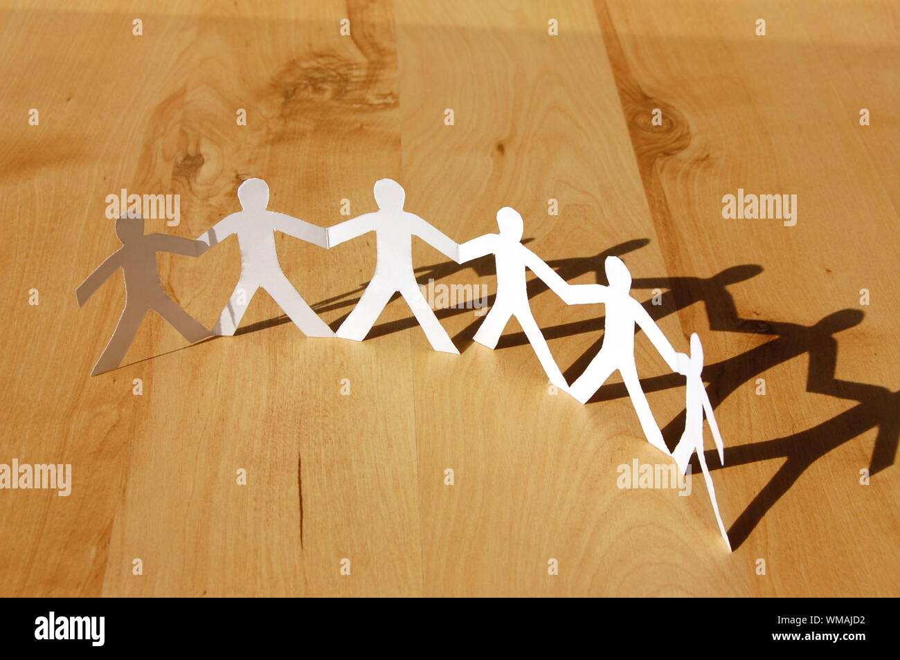 teamwork love help and family concept with paper man Stock Photo