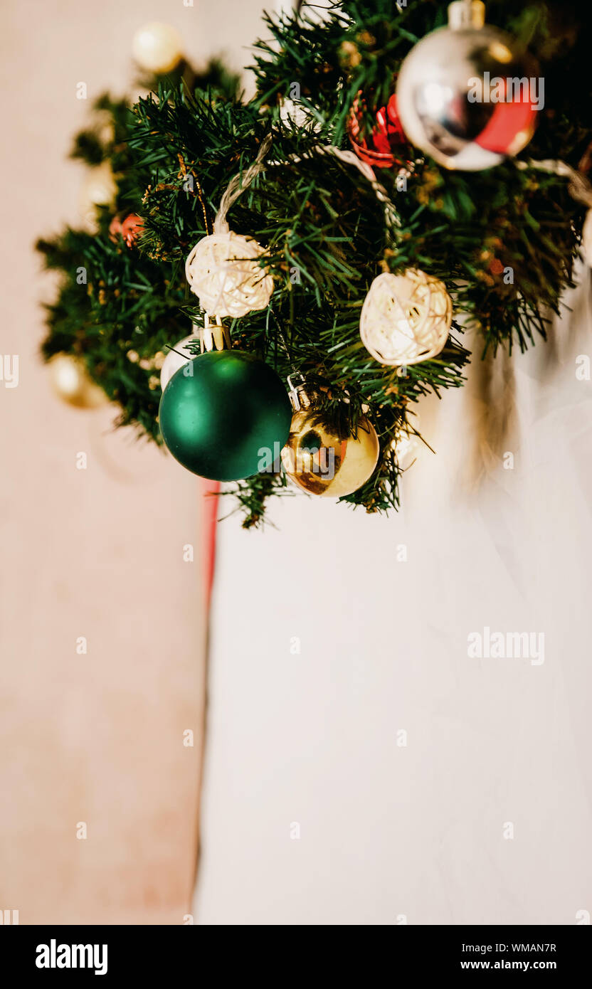 glass ball and decorations on Christmas tree. Garland with lights and ...