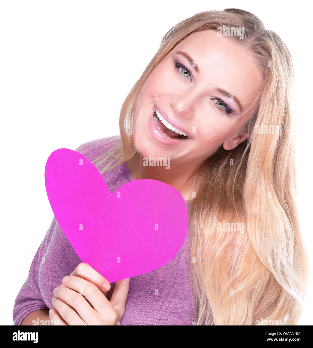Portrait of cute cheerful female with big paper heart in hands isolated ...