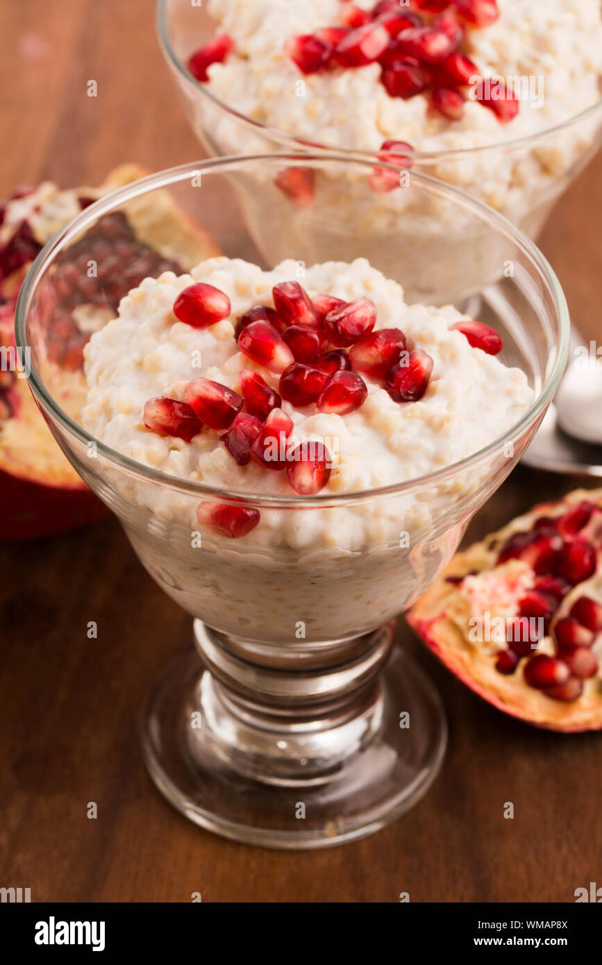 Dish of banana millet breakfast pudding with pomegranate Stock Photo