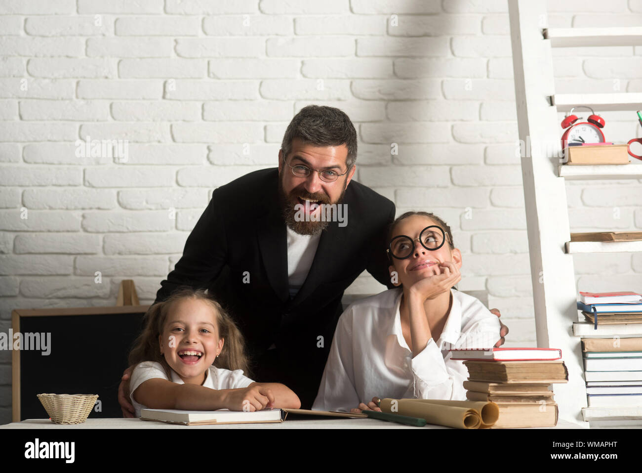 Elementary school kids and teacher sit in classroom Stock Photo - Alamy