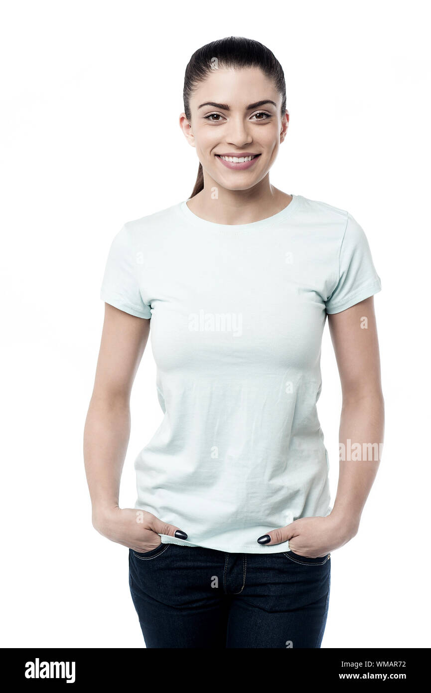 Pretty woman standing with hands in pockets Stock Photo - Alamy