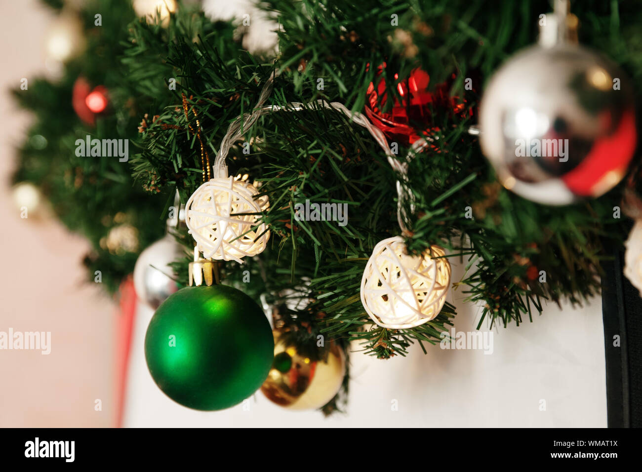 glass ball and decorations on Christmas tree. Garland with lights and ...