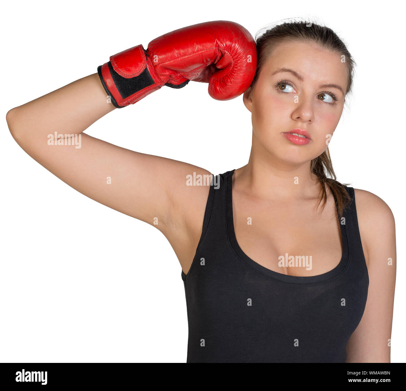 Woman holding boxing glove at her temple, looking to her right. Isolated on white background Stock Photo