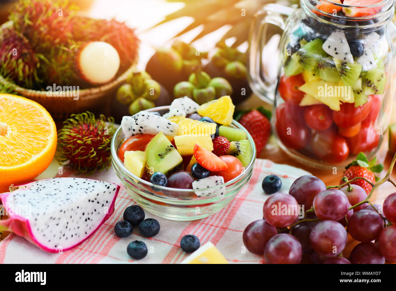 Fruit salad bowl fresh summer fruits and vegetables healthy organic food strawberries orange ...