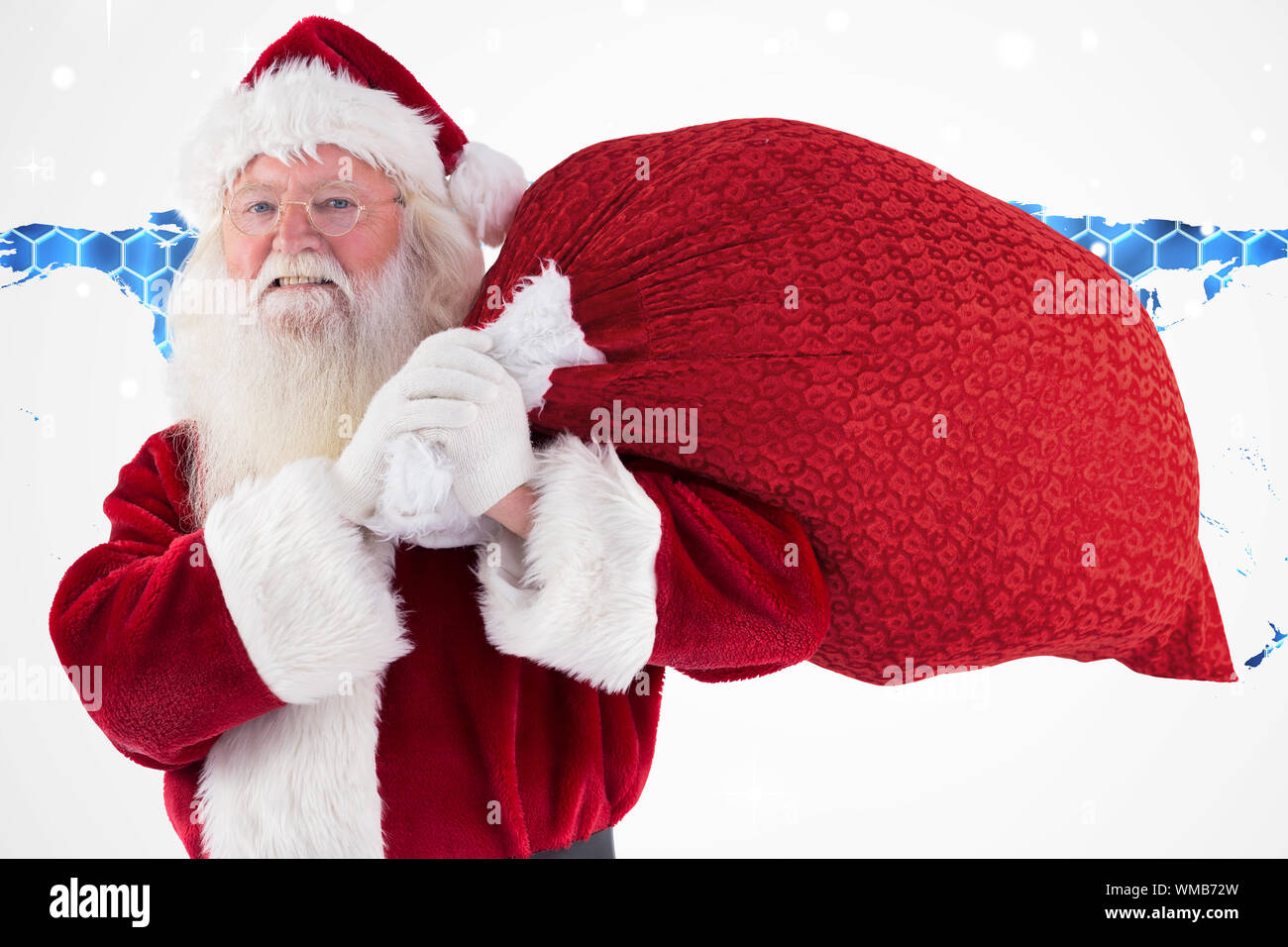 Santa carries his red bag and smiles against background with hexagons ...