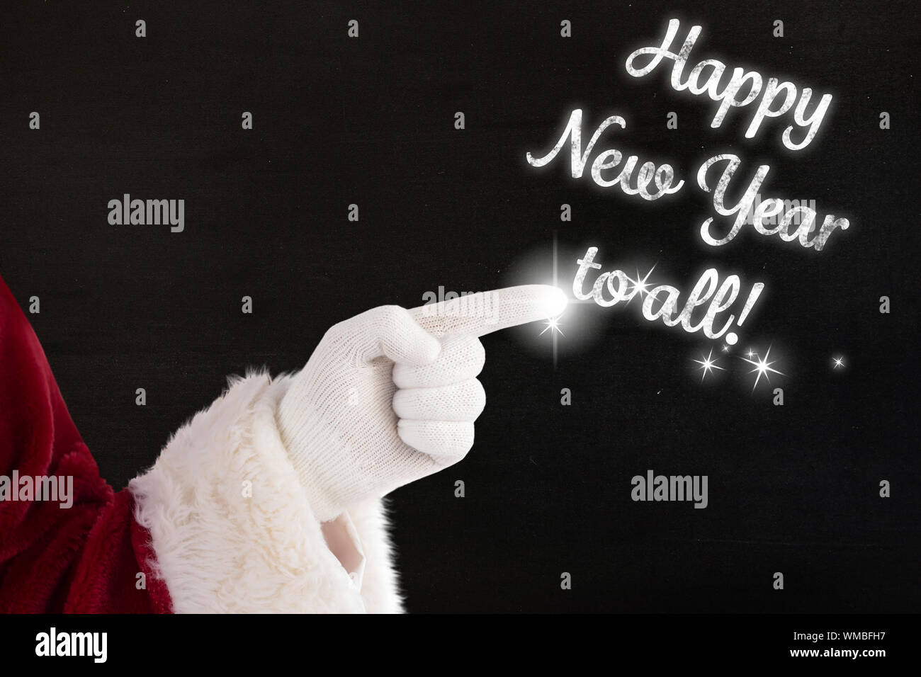 Santa claus points at something against black Stock Photo