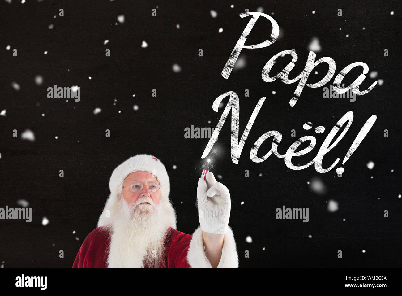 Santa writes something with a pen against black Stock Photo - Alamy