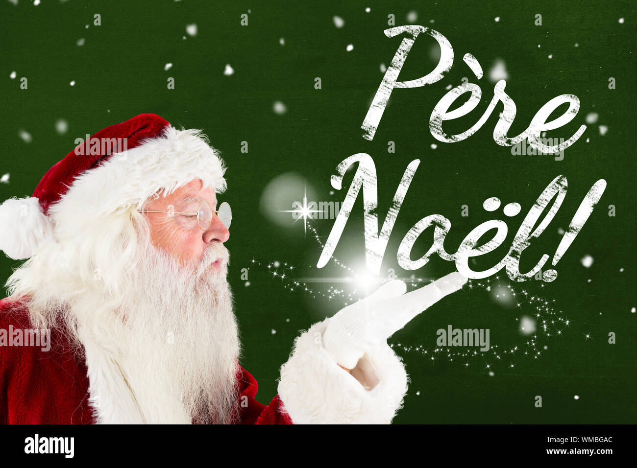 Santa claus blowing christmas massage against green Stock Photo - Alamy