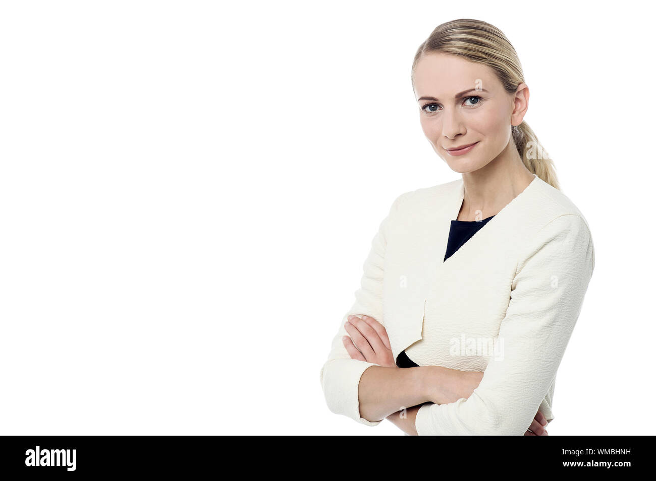 Attractive young woman posing with crossed arms Stock Photo - Alamy