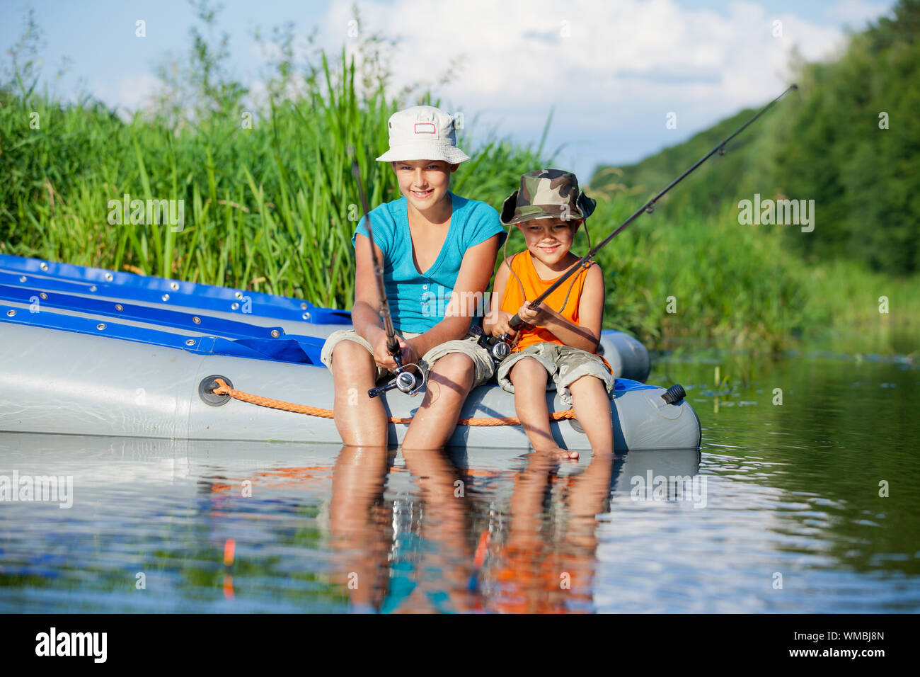 Happy brother and sister fishing at sea during summer vacation Stock Photo  - Alamy