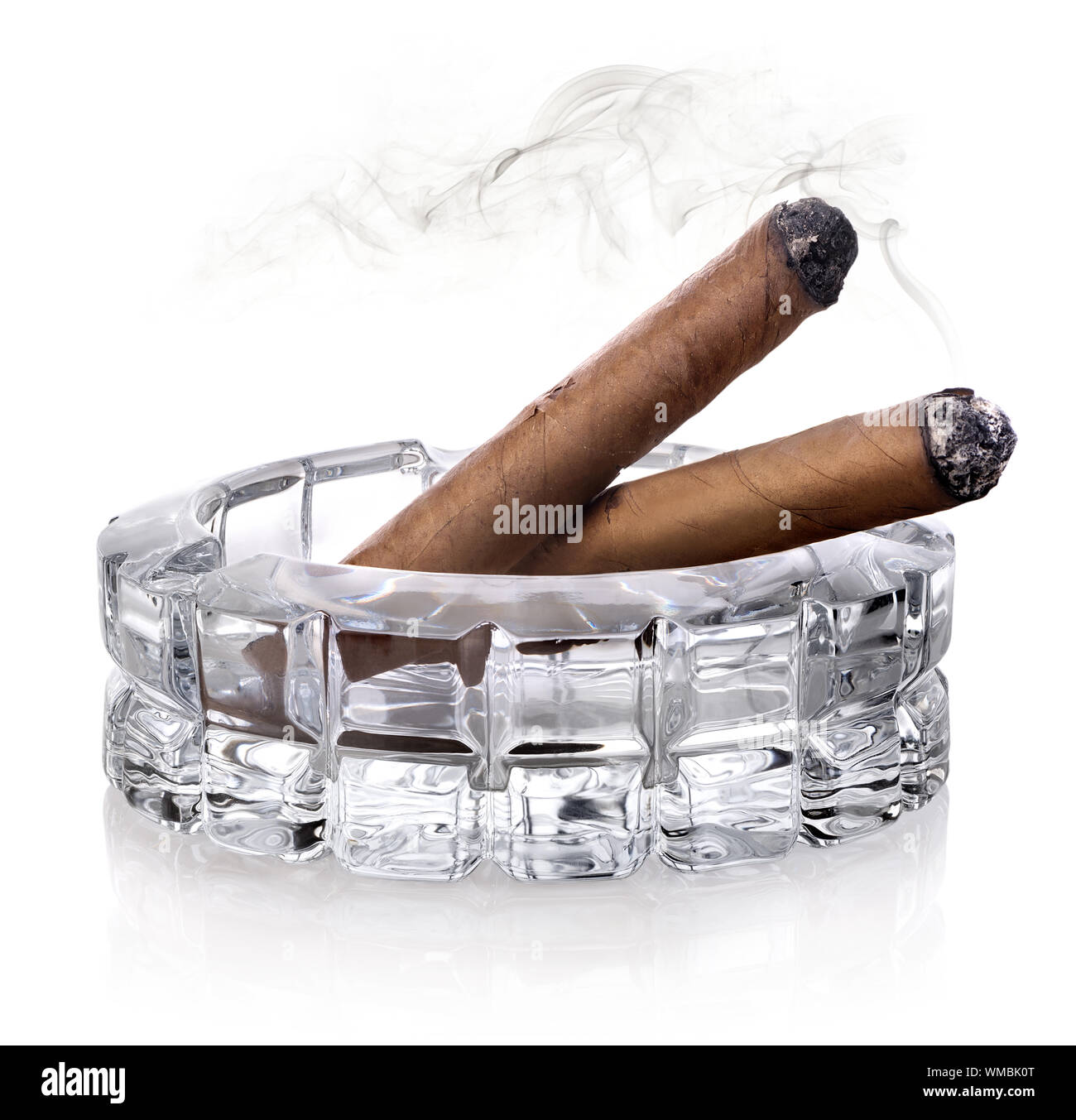 Two cigars in a glass astray isolated on white Stock Photo