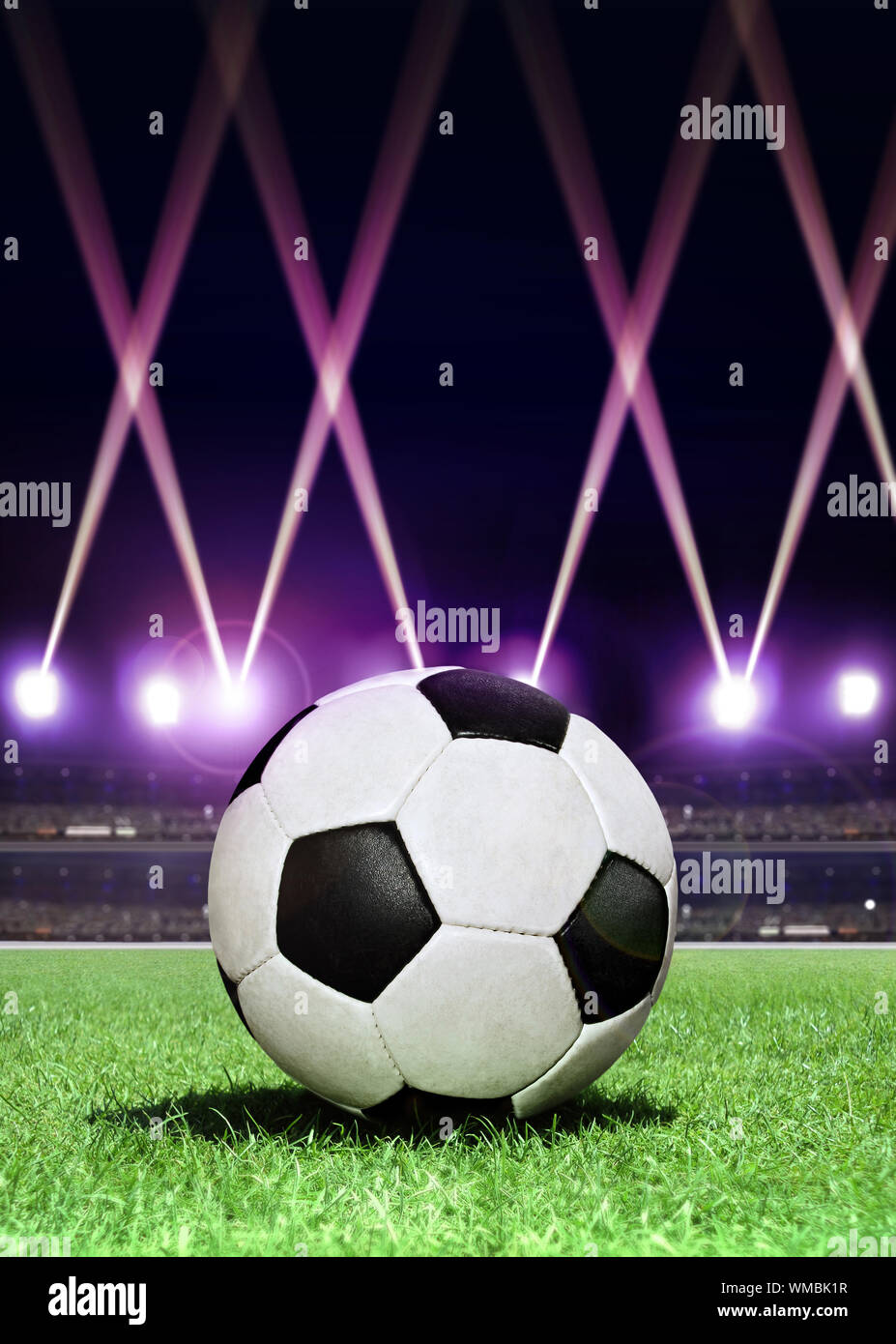 soccerball in the center of stadium during festive lighting at evening Stock Photo