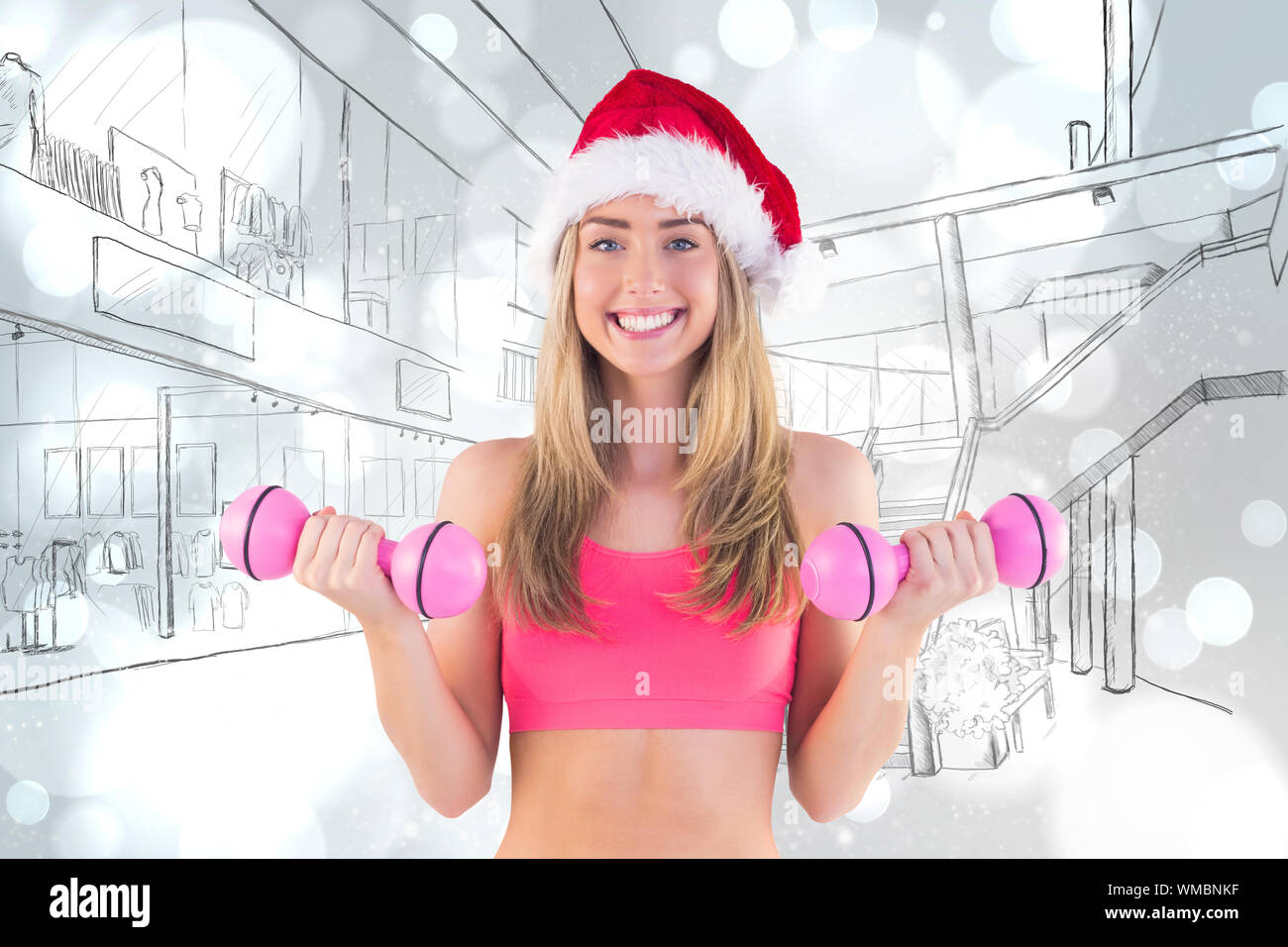 Festive fit blonde holding dumbbells against white glowing dots on grey Stock Photo