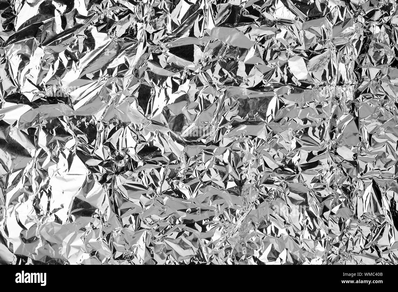 Crumpled silver foil shining texture background, bright shiny festive design, metallic glitter surface, holiday decoration backdrop concept, metal Stock Photo