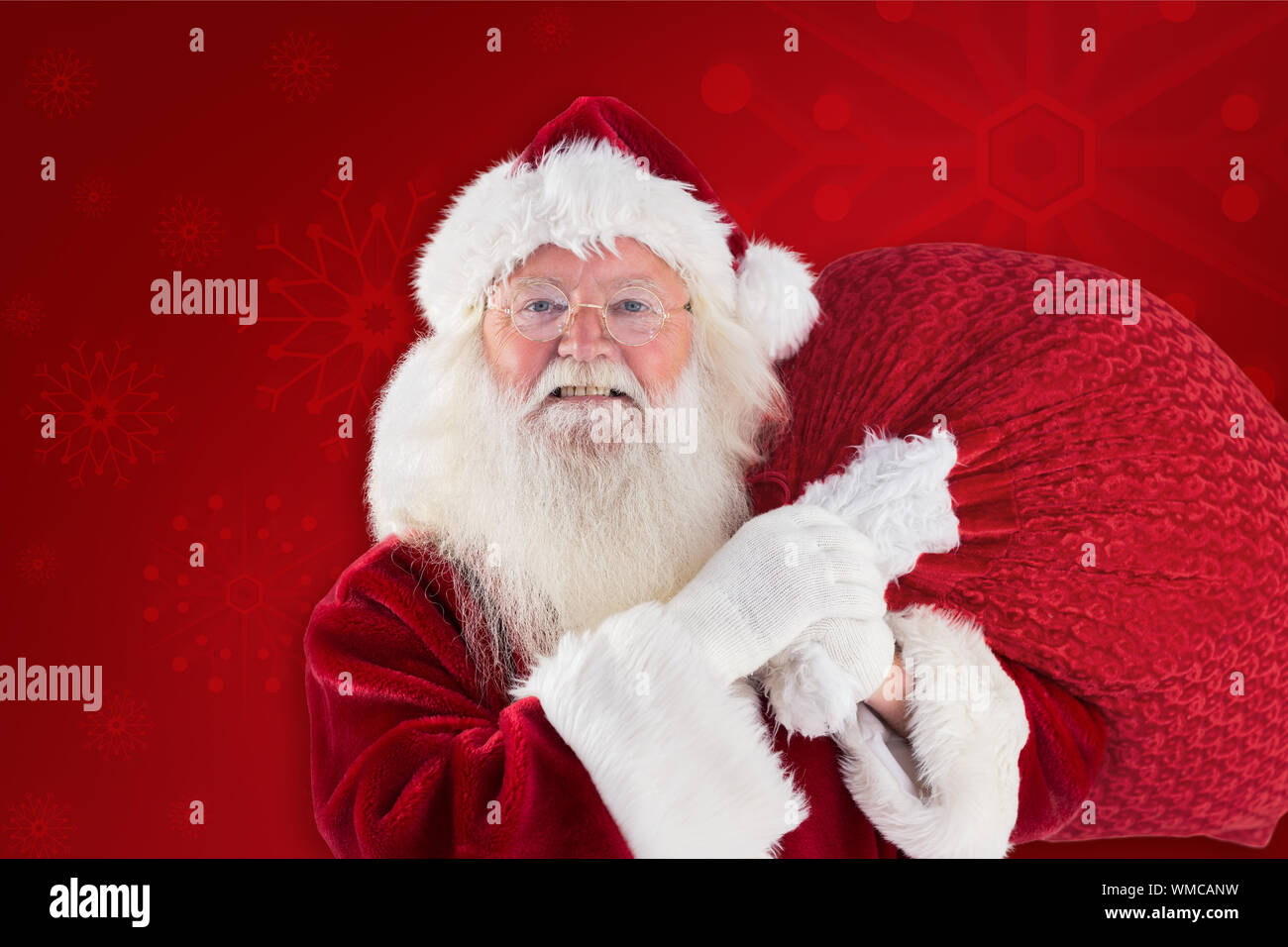 Jolly Santa carries his sack against red background Stock Photo - Alamy