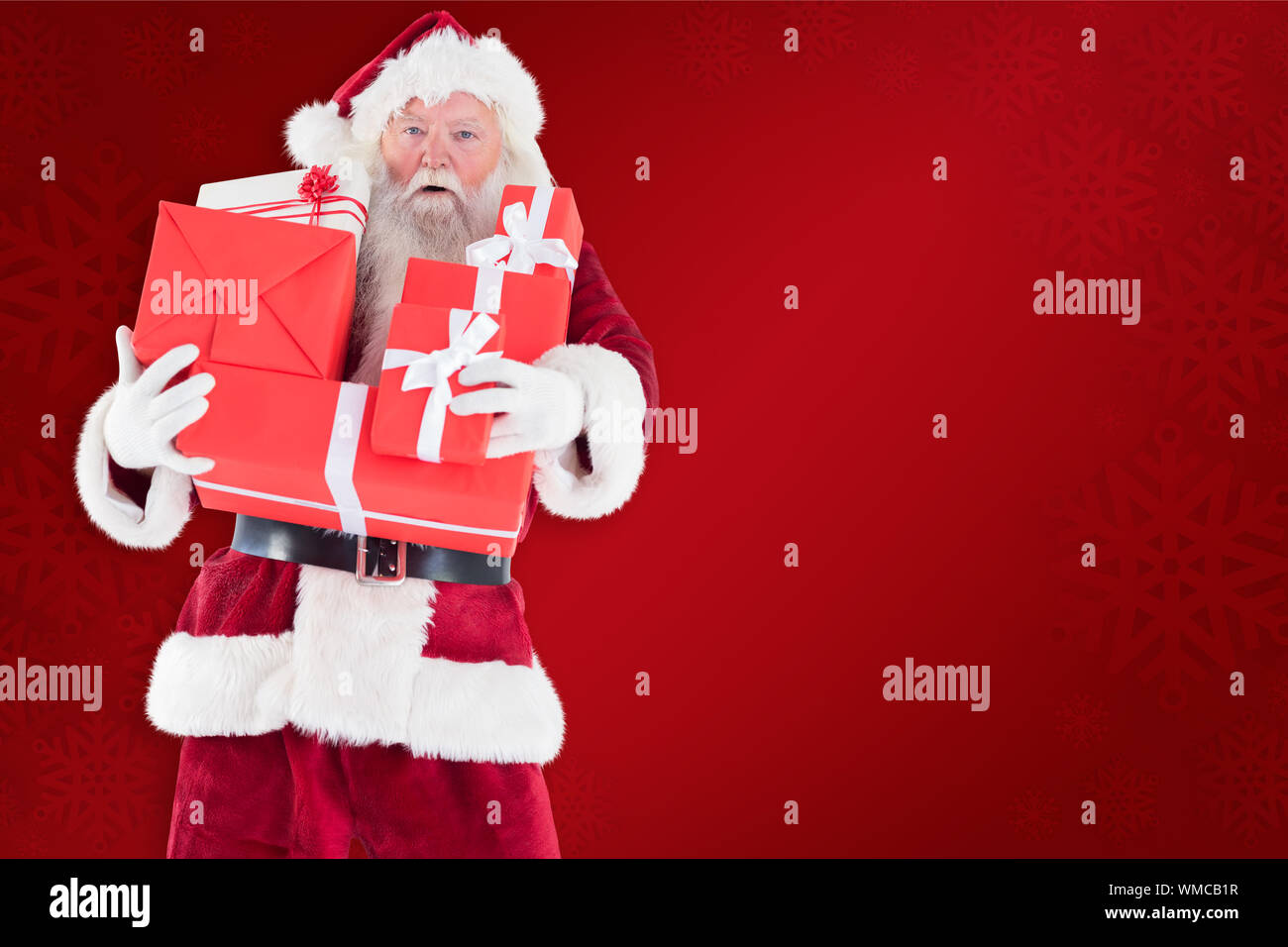 Santa carries a few presents against red background Stock Photo - Alamy