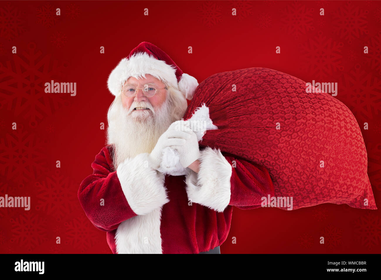 Composite image of santa claus carrying sack against red background Stock Photo