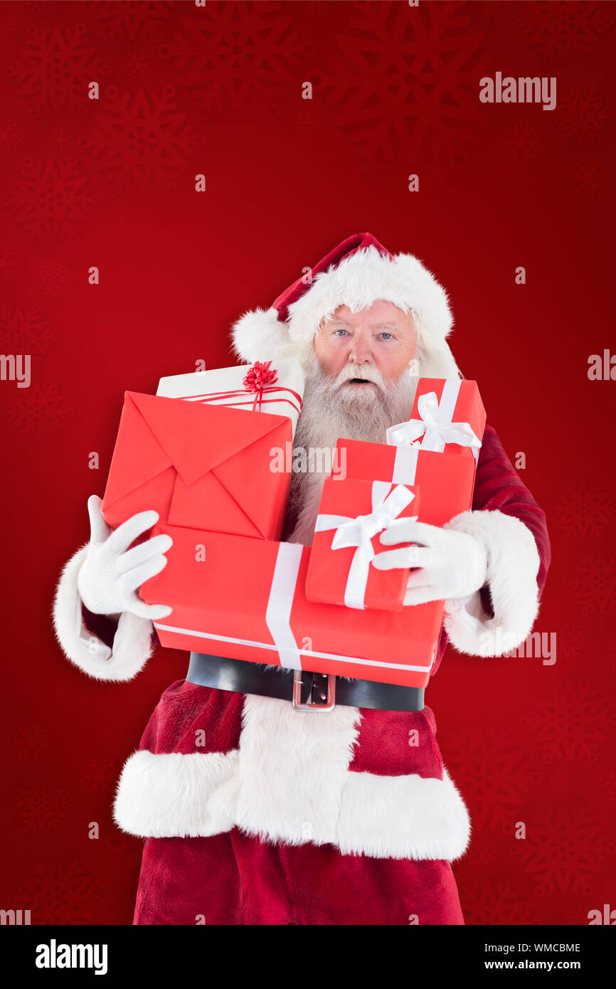 Santa carries a few presents against red background Stock Photo - Alamy