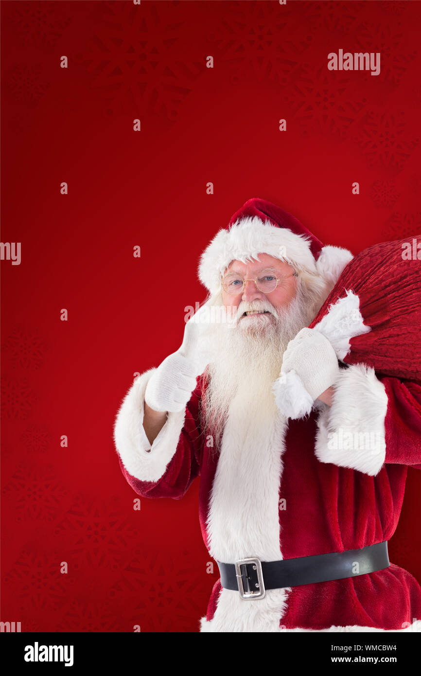 Santa likes to carry his sack against red background Stock Photo - Alamy