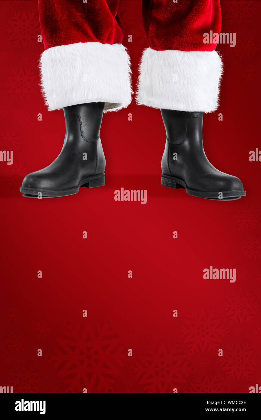 Santa claus boots against red background Stock Photo - Alamy
