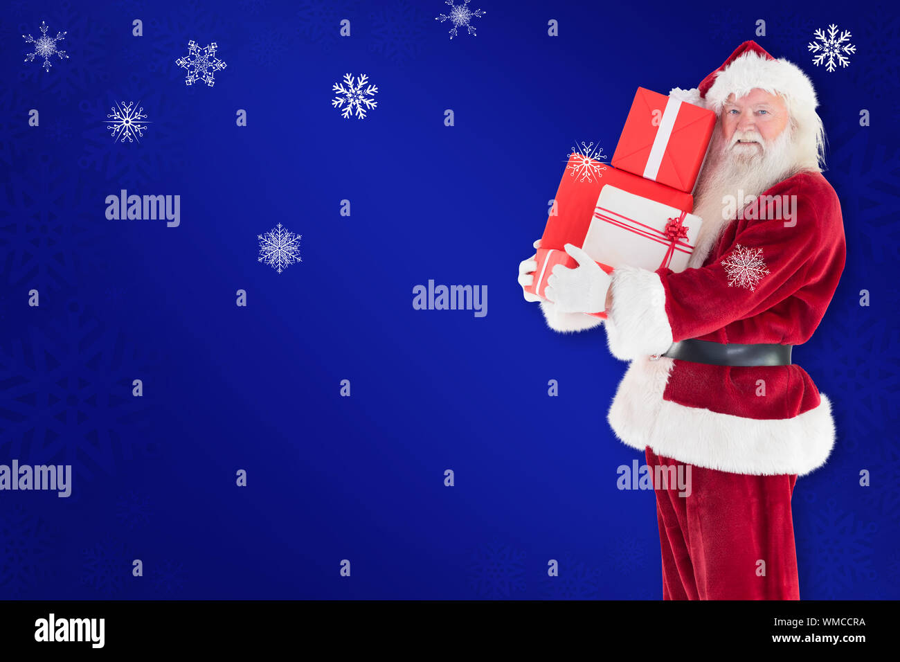 Santa carries a few presents against blue snowflake background Stock ...