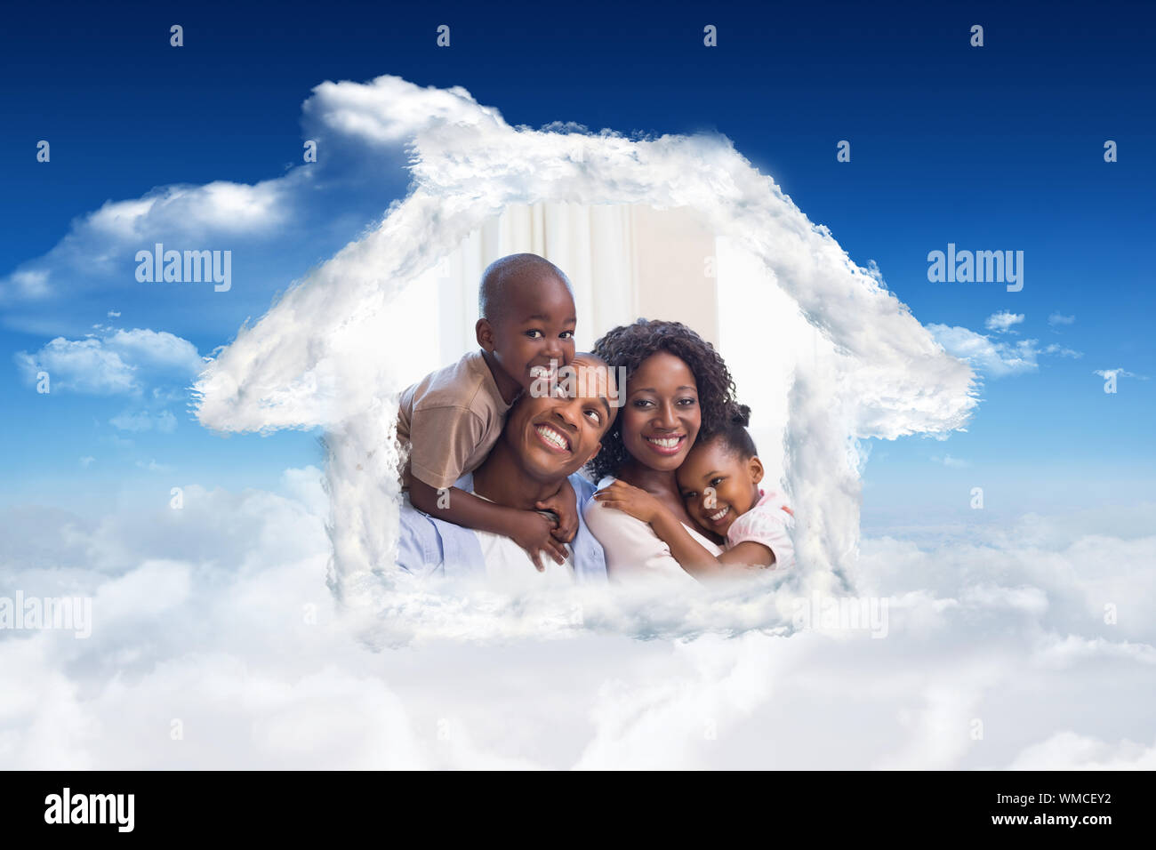 Happy family posing on the couch together against bright blue sky with