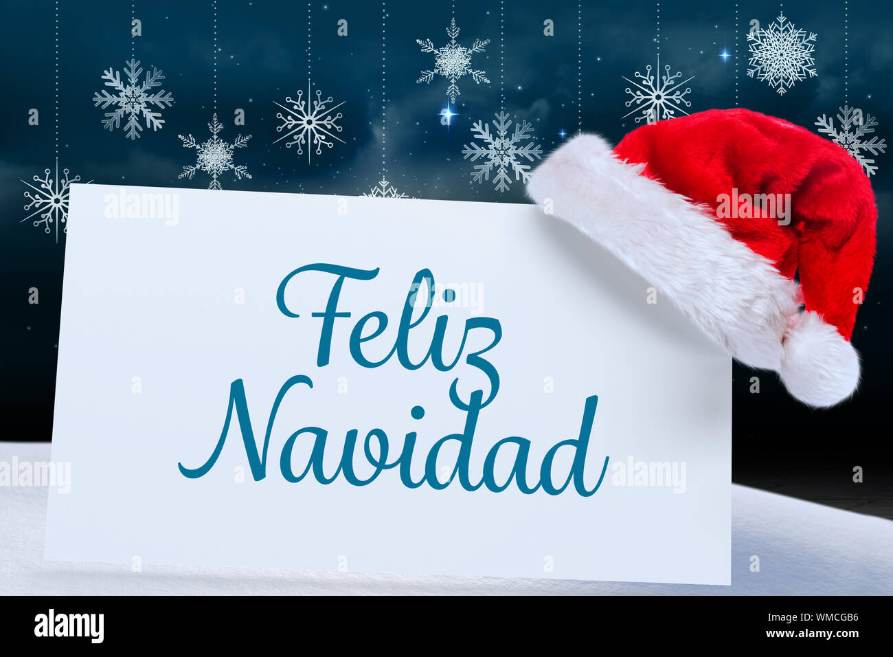 Feliz navidad against snowflake wallpaper over floor boards Stock Photo - Alamy