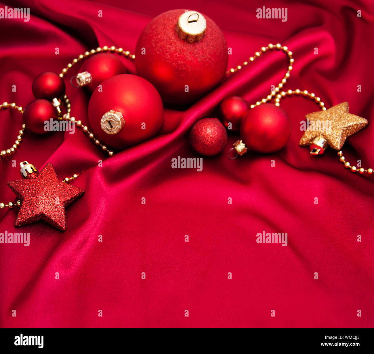 Red and gold christmas baubles on the red silk background Stock Photo ...