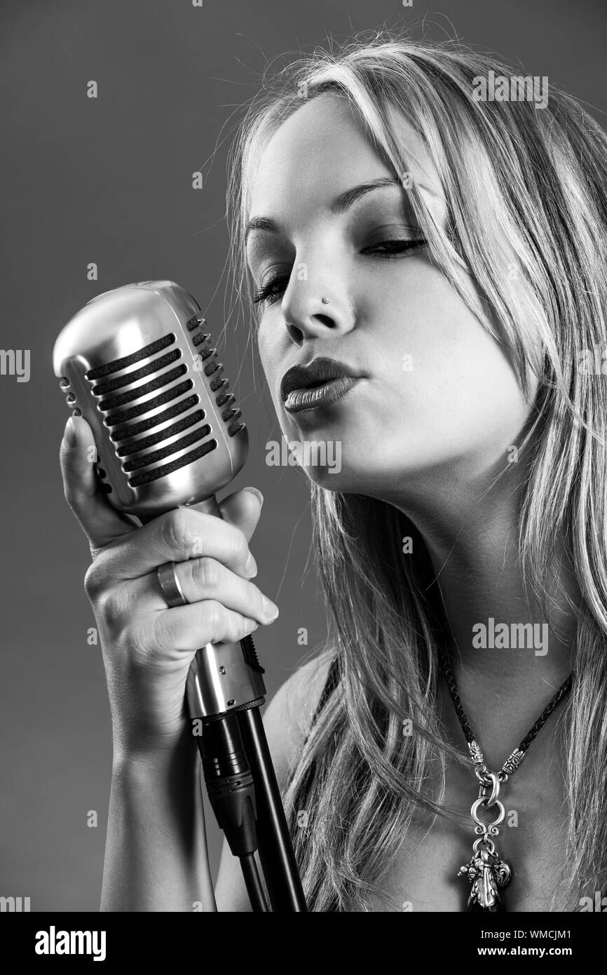 Black woman singing into microphone Black and White Stock Photos ...