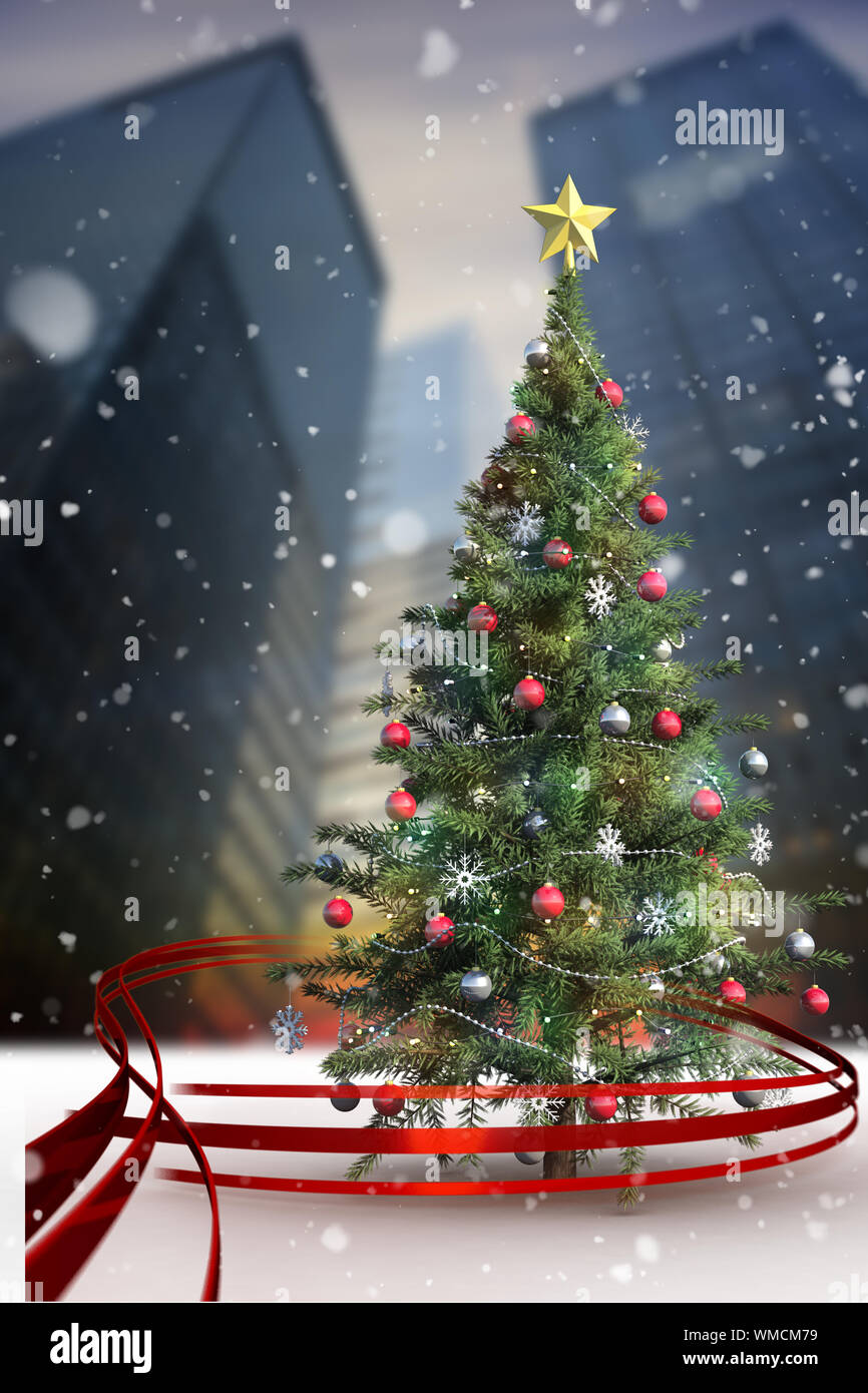 Composite image of christmas tree with falling snow Stock Photo - Alamy