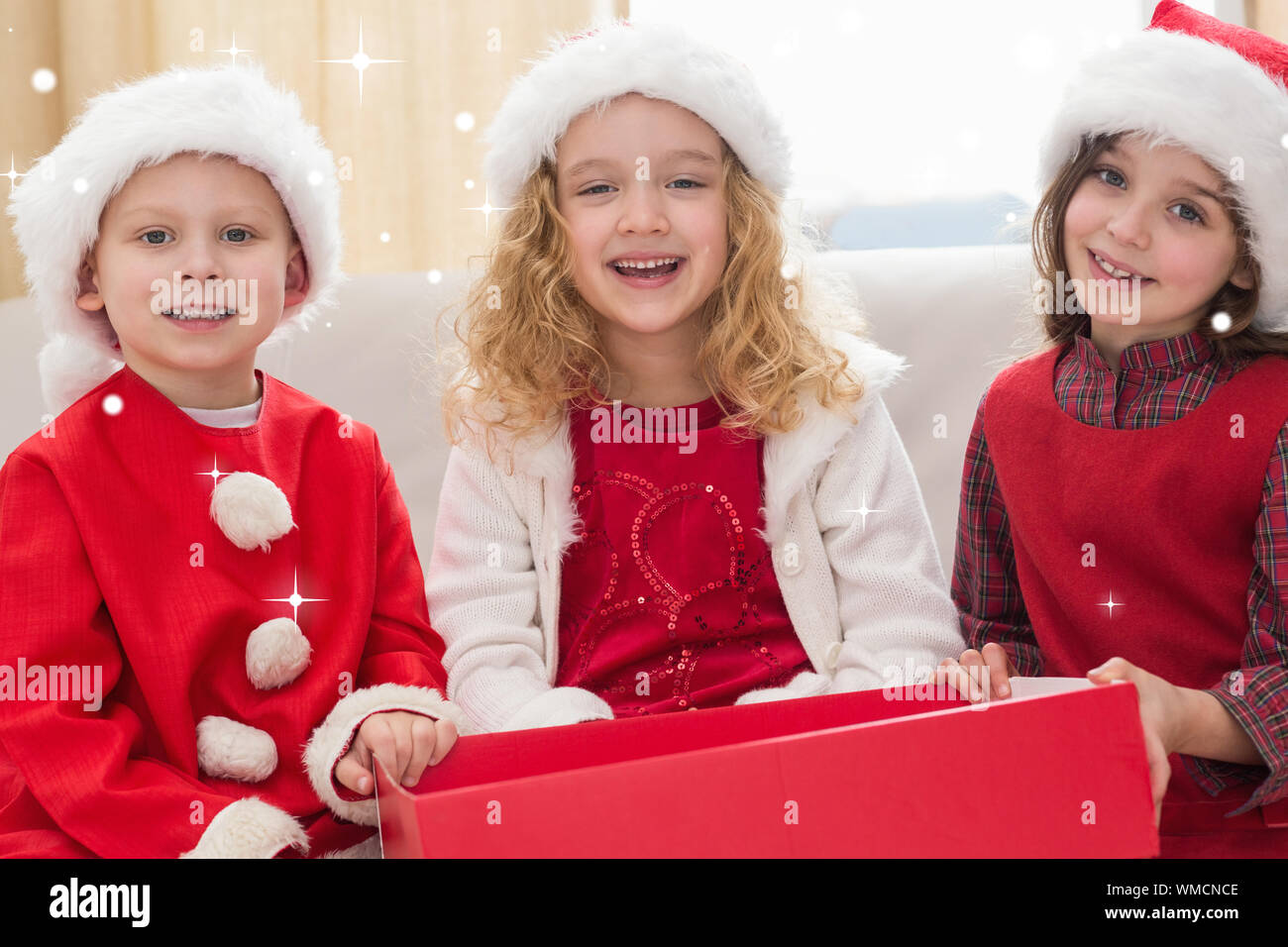 Festive little siblings smiling at camera against snow Stock Photo - Alamy