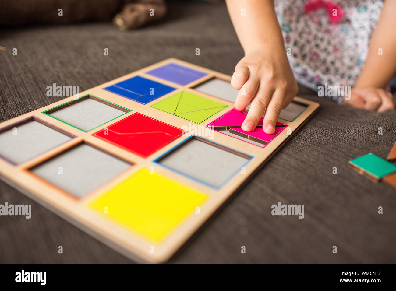 Little Girl S Hands Playing With A Wood Mosaic On A Sofa Educational Games Montessori Preschool Early Develop Stock Photo Alamy