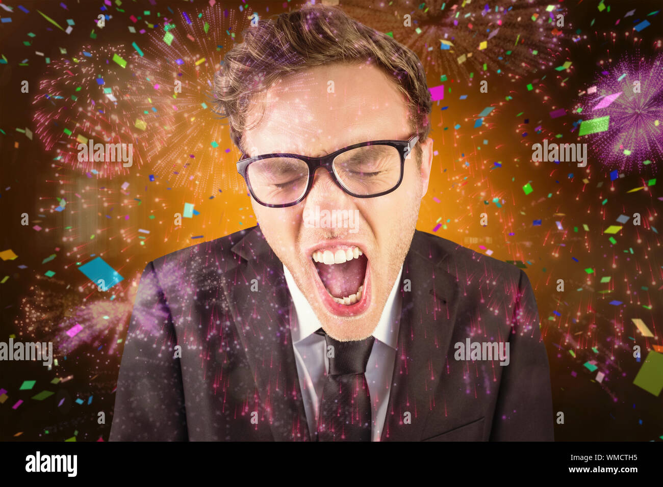 Young angry businessman shouting at camera against colourful fireworks ...