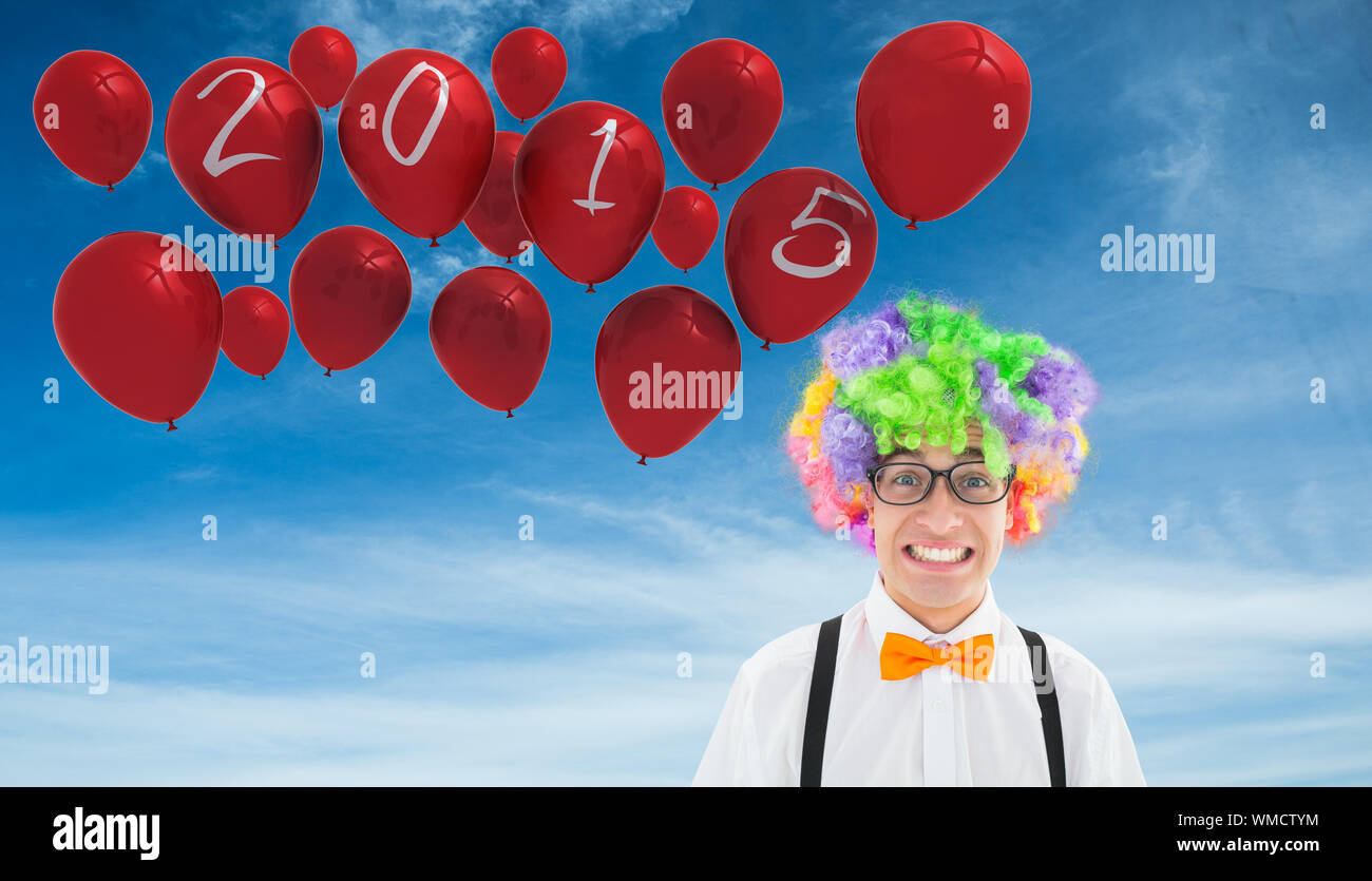 Geek in afro wig against blue sky Stock Photo