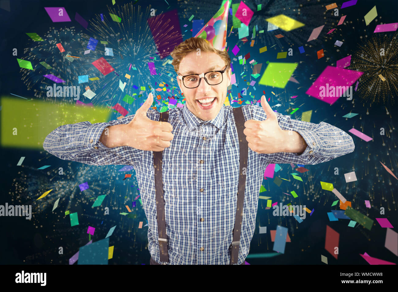 Geeky hipster wearing party hat smiling at camera against white ...
