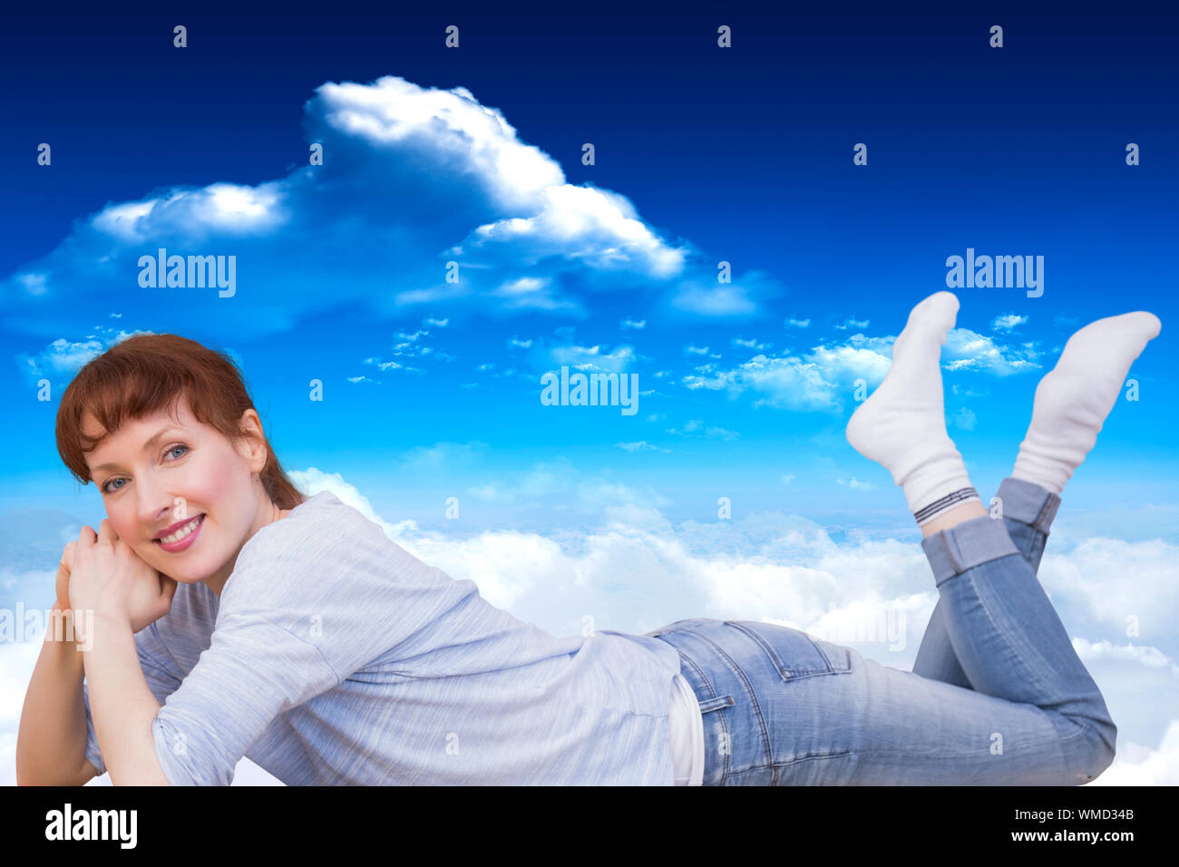 Woman lying on the floor against bright blue sky with clouds Stock ...