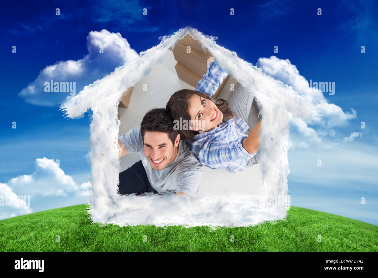 Overview of couple giving thumbs up against green field under blue sky Stock Photo