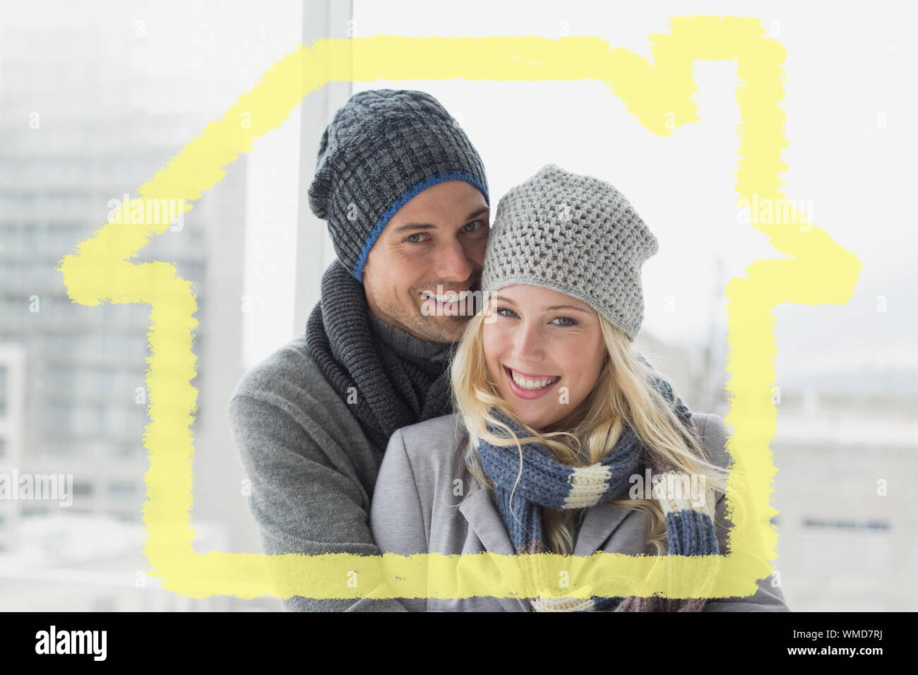 Cute couple in warm clothing smiling at camera against house outline ...
