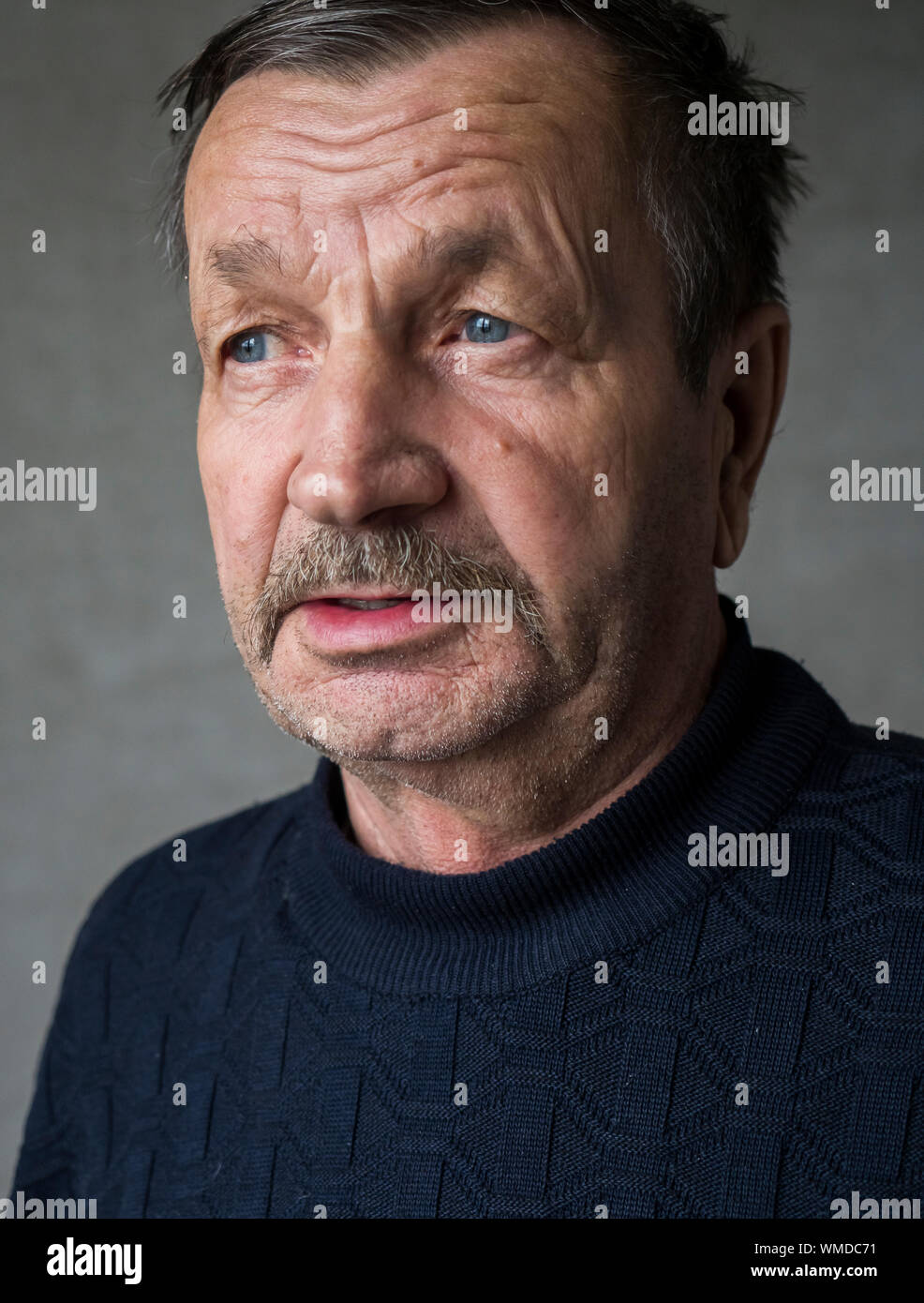 Senior Man Against Gray Background Stock Photo
